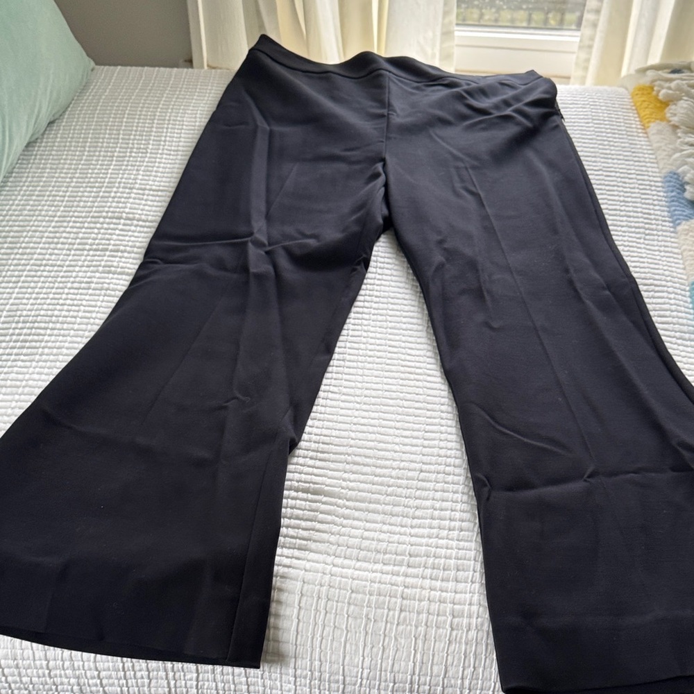 Black wide leg side zip trouser by Reformation.